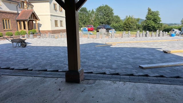 Driveway groundworks beside an oak porch